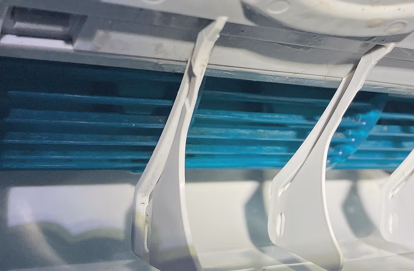 Close-up of the inner vents and plastic fins of an air conditioning unit.