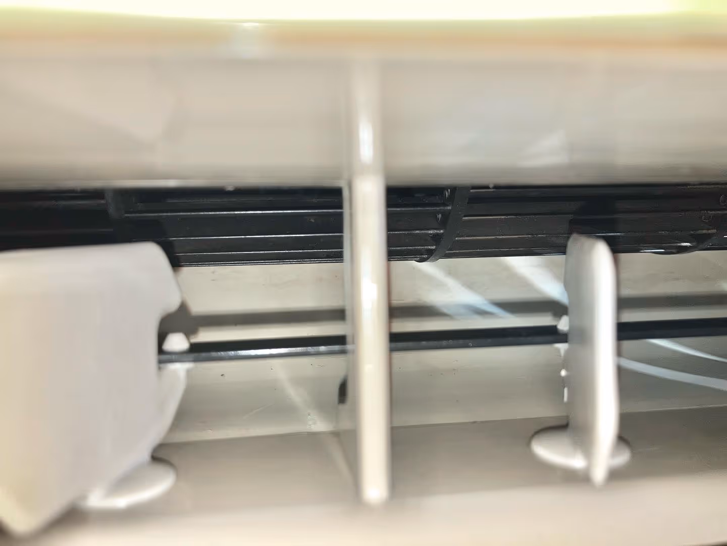 Close-up view of the air vents and adjustable slats inside an air conditioning unit.